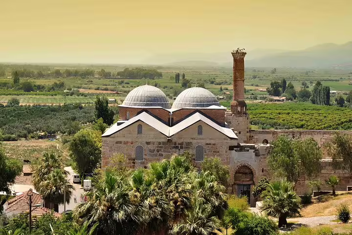 Discover the beautiful Isa Bey Mosque near Ephesus, showcasing Ottoman architecture with picturesque countryside views.