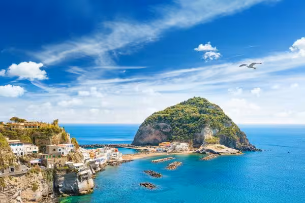 Panoramic view of Sant’Angelo bay and rocky islet on Ischia boat tour, ideal for scenic cruising and swimming