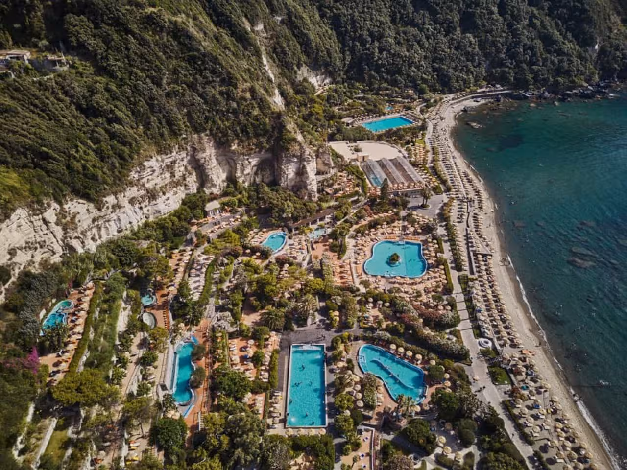 Aerial view of Ischia Poseidon Gardens thermal park by Citara Beach, pools and sunbeds with hotel transfer