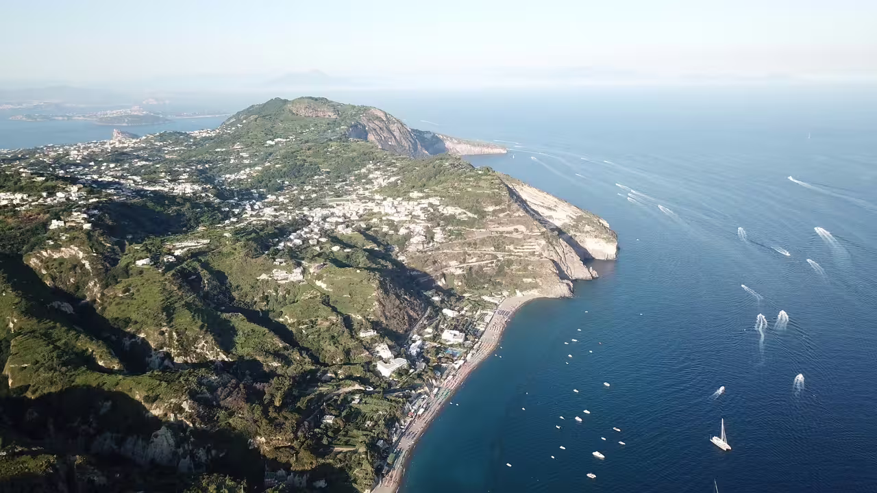 Aerial view of Ischia coastline near Sant’Angelo and Maronti Beach, day trip with transfers from Naples