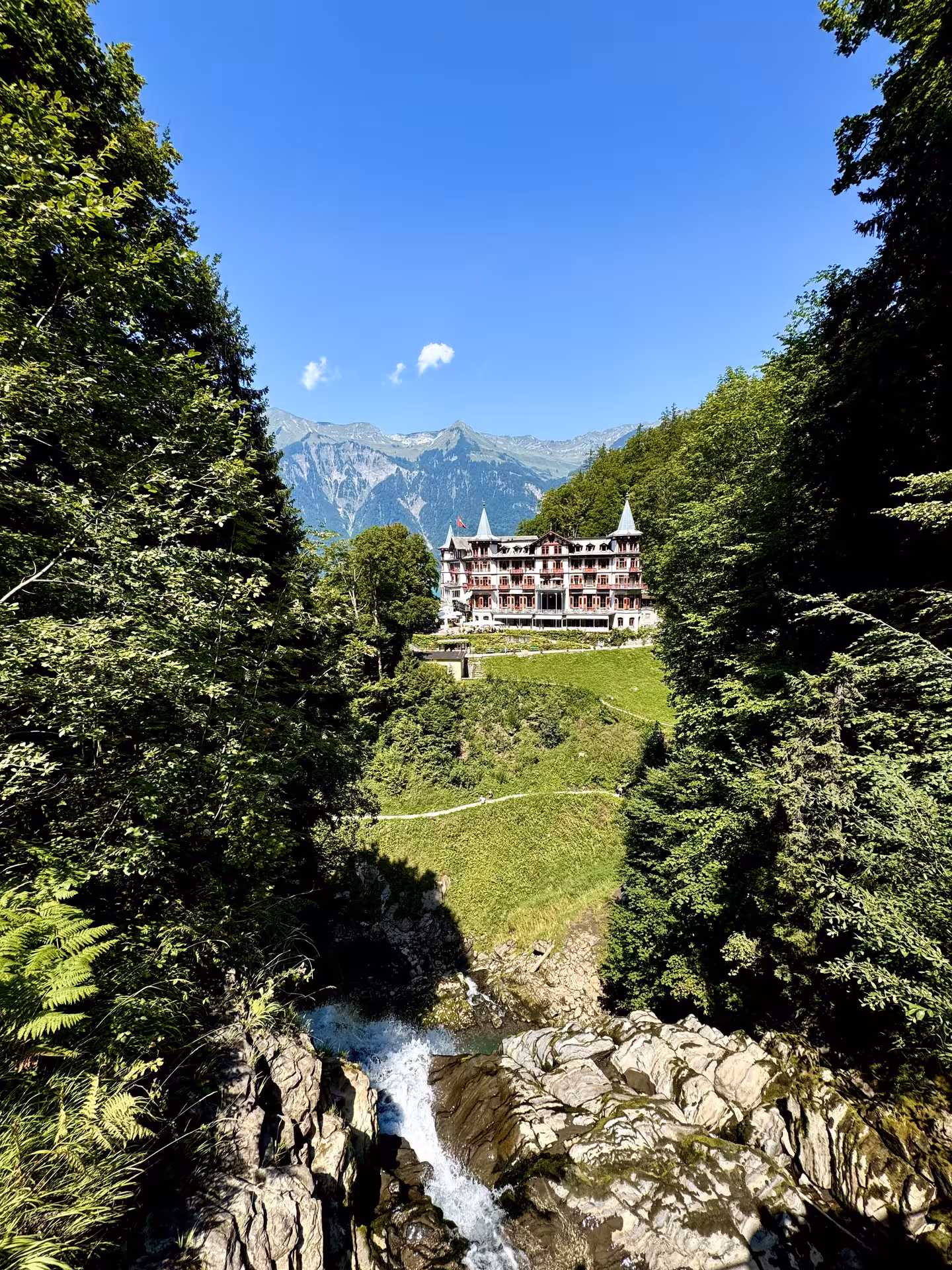 Panoramic view of Grand Hotel Giessbach and Lake Brienz cliffs on Iseltwald to Giessbach e-bike tour route
