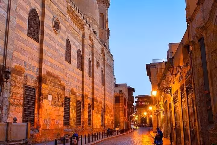 Evening street in Historic Islamic Cairo by a grand mosque, on a guided walking tour through old Cairo