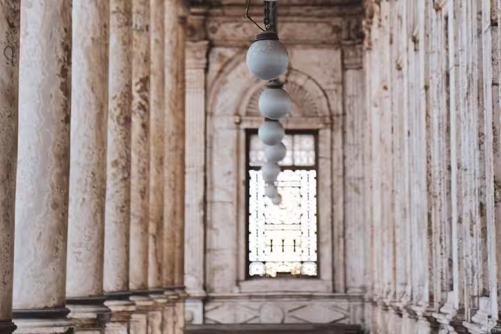 Historic Cairo mosque corridor with marble columns and hanging lamps, Islamic Cairo day tour in Egypt
