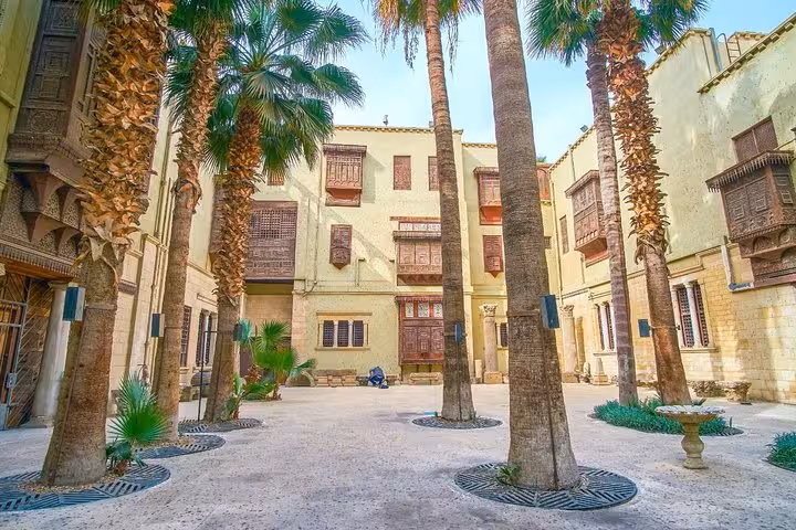 Palm-lined courtyard with traditional mashrabiya windows in Old Cairo, part of Islamic and Coptic Cairo tour