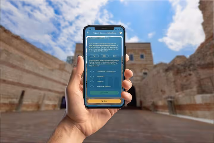 Hand holding smartphone with Istanbul 1453 siege quiz app at Blachernae Palace ruins