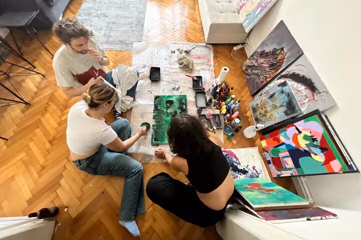 Top view of Istanbul art escape wine and paint at a local’s home, group crafting colorful abstract canvases