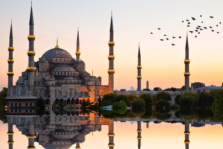 Sunset view of the Blue Mosque in Istanbul, reflected in water, perfect for a private guided tour experience.