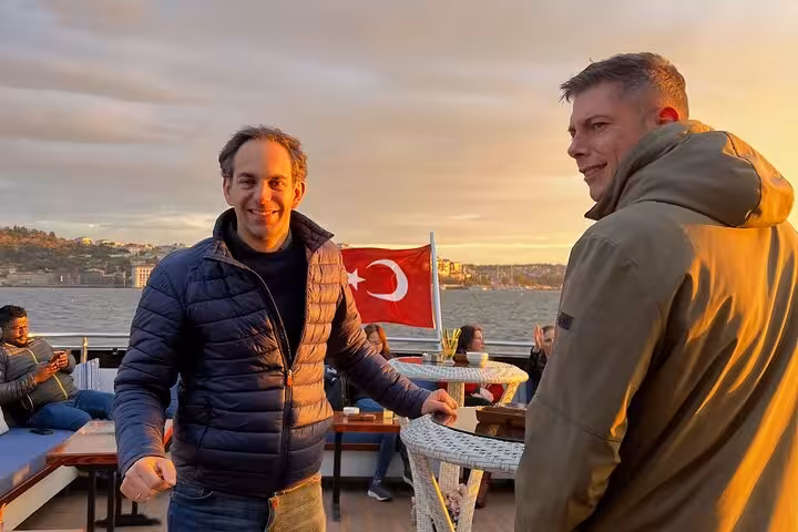 Travelers enjoy an Istanbul Bosphorus sunset cruise on a luxury yacht with Turkish flag and wine service