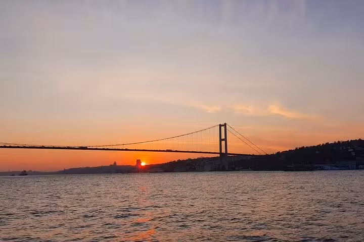 Sunset over the Bosphorus Bridge on an Istanbul luxury yacht cruise with panoramic sea views