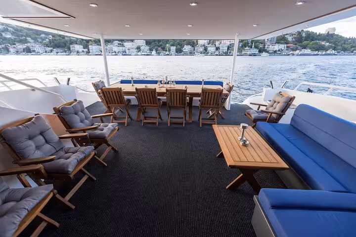 Spacious aft deck seating on private Istanbul Bosphorus yacht cruise with dining table and sea views