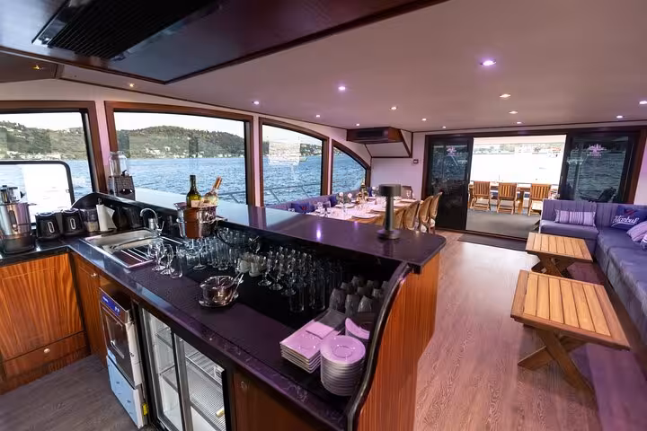 Spacious indoor lounge and bar on private Istanbul Bosphorus yacht cruise with panoramic sea views