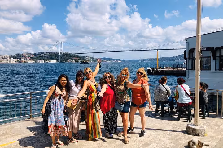 Spanish tour group by the Bosphorus with bridge view in Istanbul, part of 6-day Istanbul Cappadocia trip