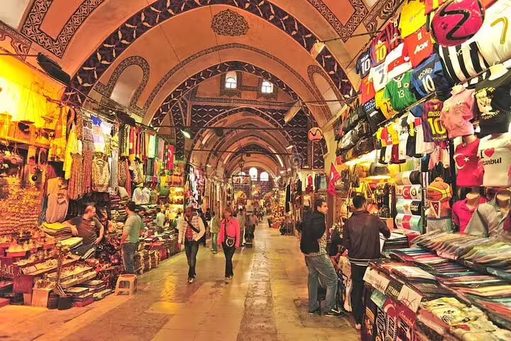 Colorful stalls in Istanbul's Grand Bazaar showcasing textiles and souvenirs on a guided private tour.
