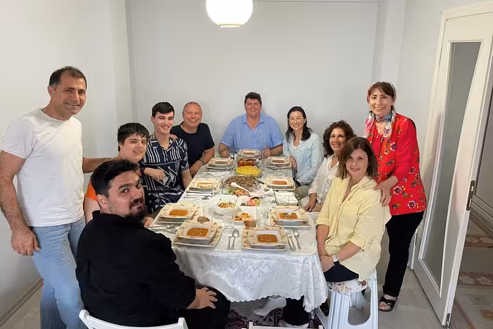 Group enjoying a homemade Turkish dinner with locals in Istanbul, a highlight of the 3-day neighborhood immersion tour