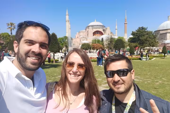 Private Istanbul tour selfie in Sultanahmet Square with Hagia Sophia and minarets on a sunny day
