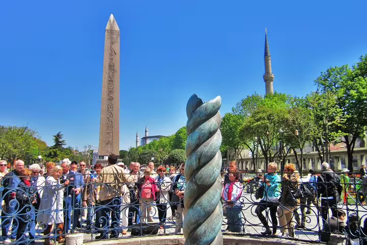 Tour group by Sultanahmet obelisk and Serpent Column, stop on Istanbul 7-hour tram tour itinerary