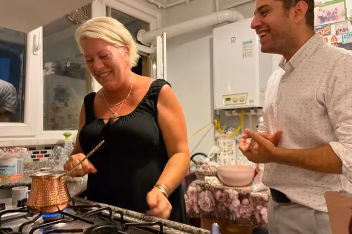 Istanbul neighborhood immersion, guests brewing Turkish coffee on the stove during a local home visit experience