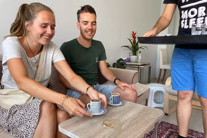 Guests enjoy Turkish coffee tasting in an Istanbul home, sipping from traditional cups with local host