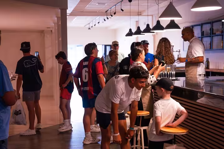 Guests enjoying Italian aperitivo drinks at a modern bar in Barcelona during a culinary experience.