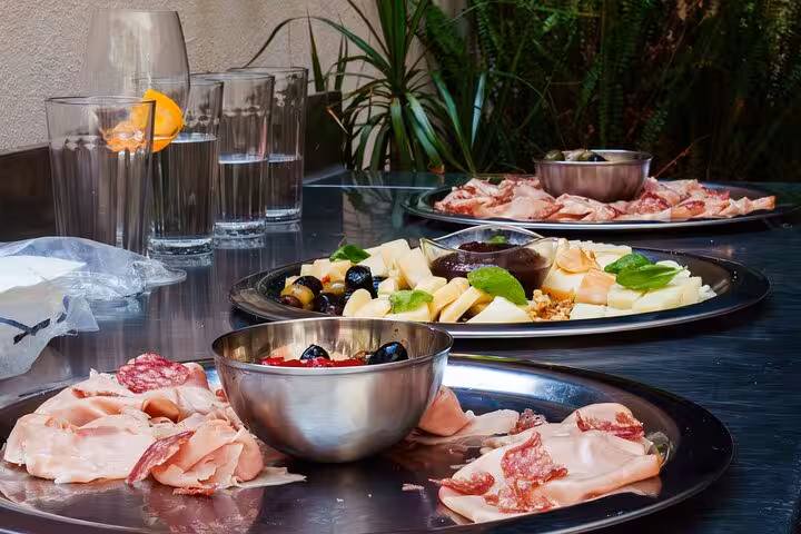 Italian aperitivo platters with meats, cheeses, and olives served in Barcelona, offering a taste of authentic flavors.