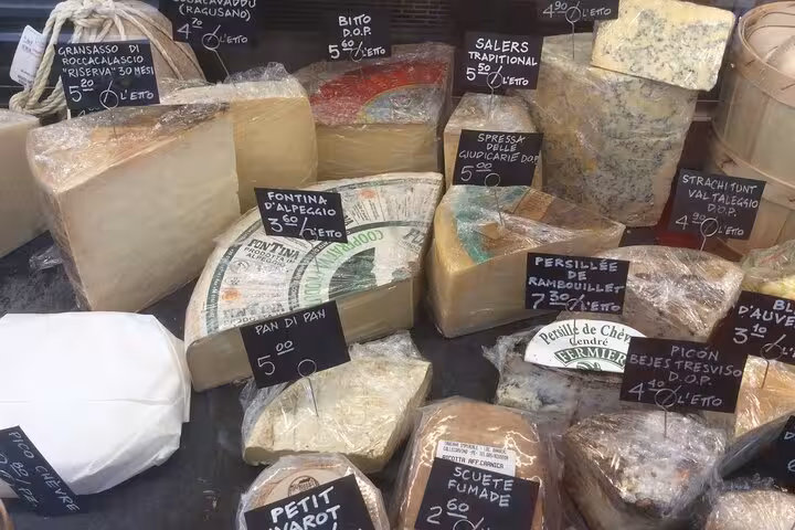 Assorted Italian cheeses in Rome's Testaccio market, showcasing local flavors on a private food tour.