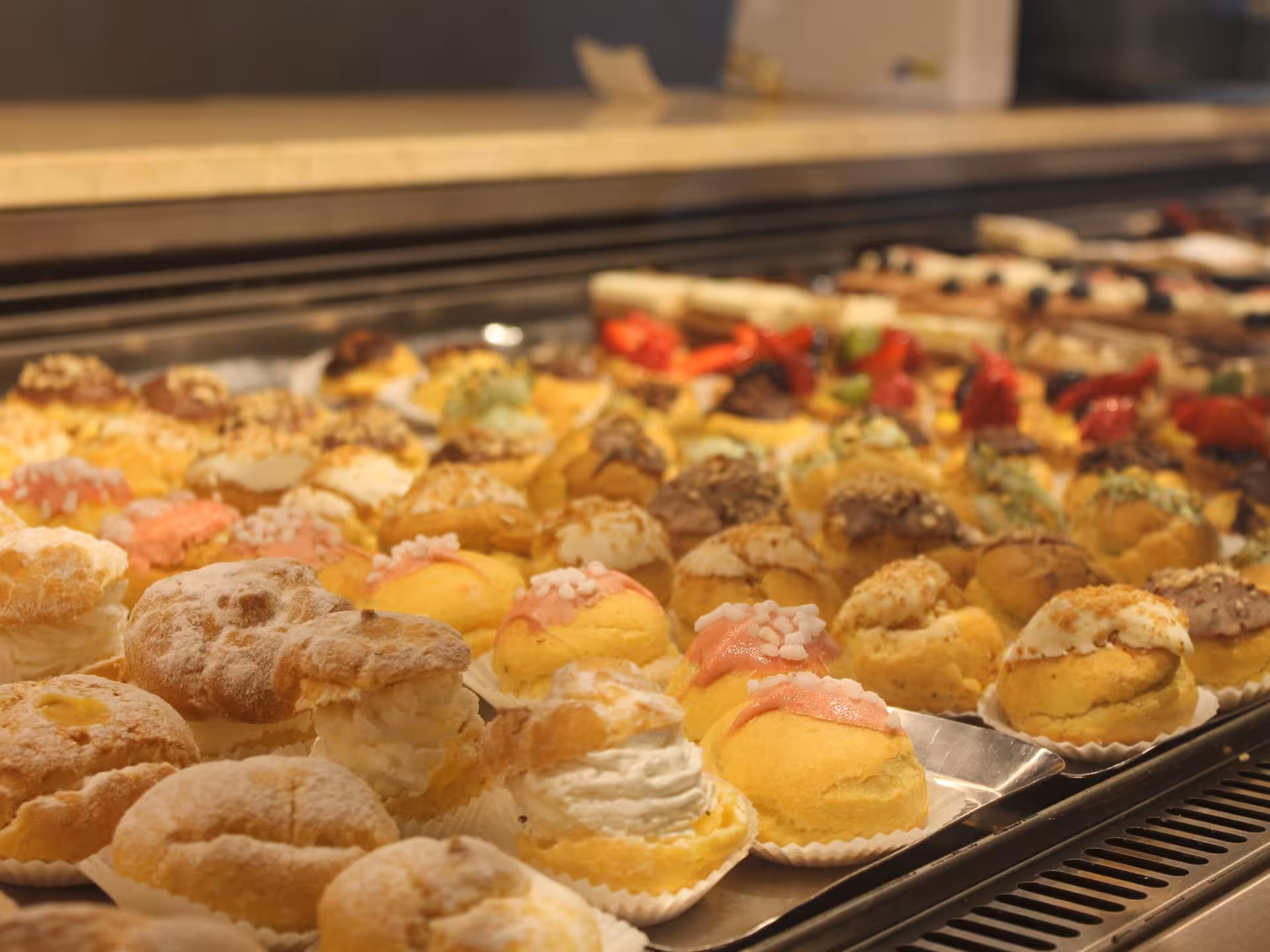 A display of assorted Italian pastries in a Parma bakery, highlighting the sweet temptations on a culinary food tour.