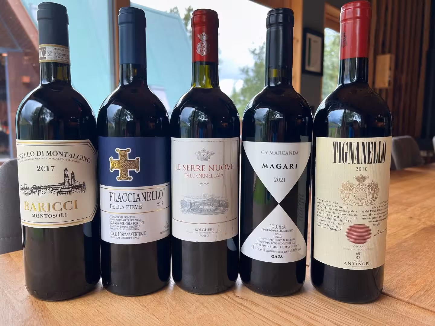 Five premium Italian red wines including Tignanello and Brunello di Montalcino for a curated lakeside wine tasting event