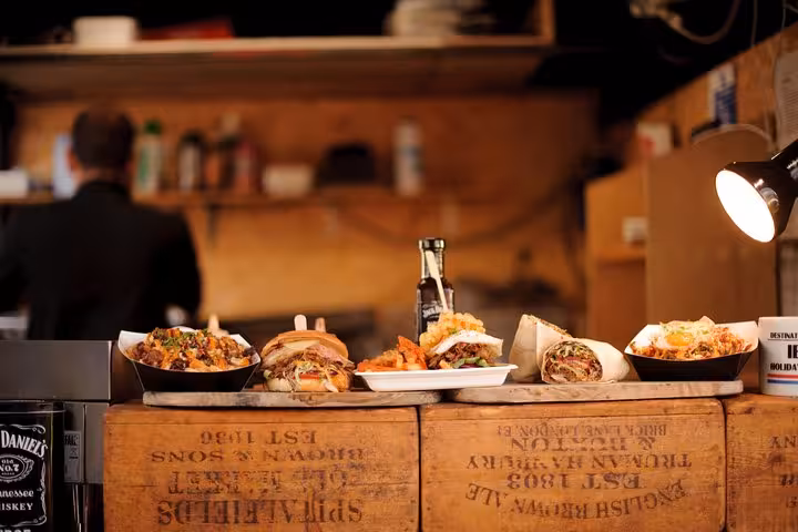 Assorted Italian street food on rustic crates in a cozy Roman kitchen during the Vatican area walking food tour.