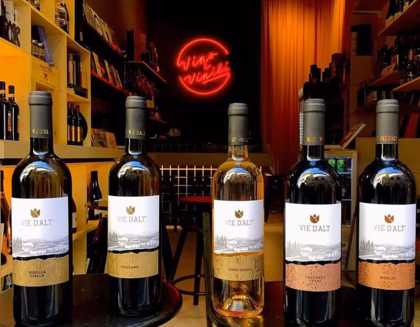 Assorted Italian wine bottles in a cozy Rome vinyl wine bar, featured on Wines & Vinyl vintage tasting tour