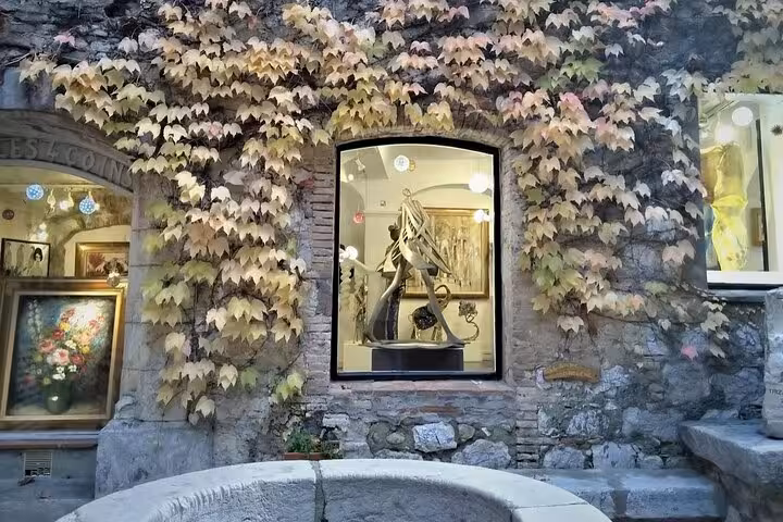 Ivy-covered stone gallery wall with sculpture display window in Provence, French Riviera