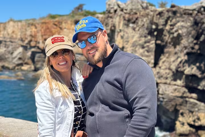 Couple posing at Boca do Inferno, capturing the dramatic cliffs and ocean backdrop on the Sintra tour.