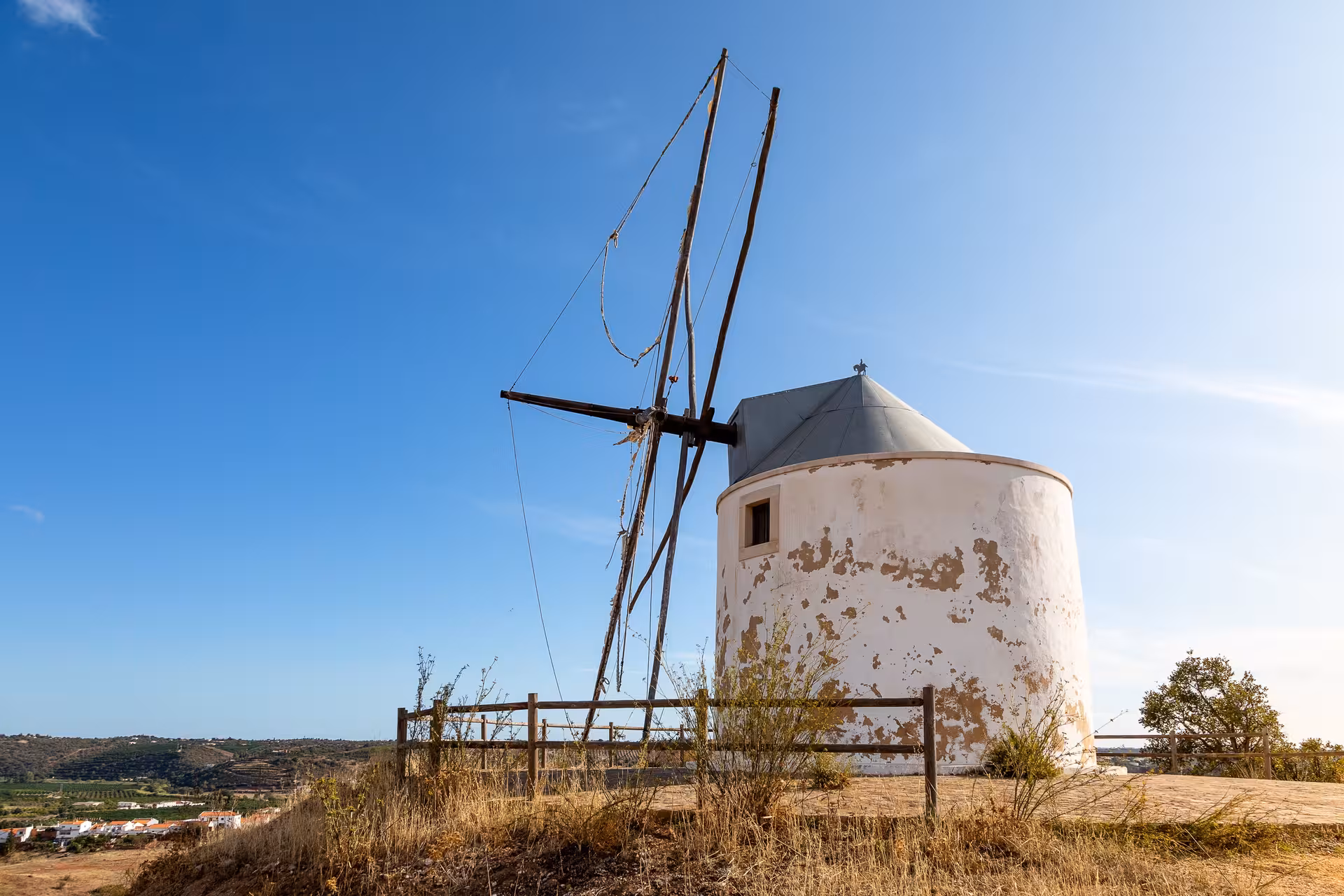 Historic hilltop windmill overlooking rural Algarve landscape, visited on off-road Jeep safari adventure tour in Portugal