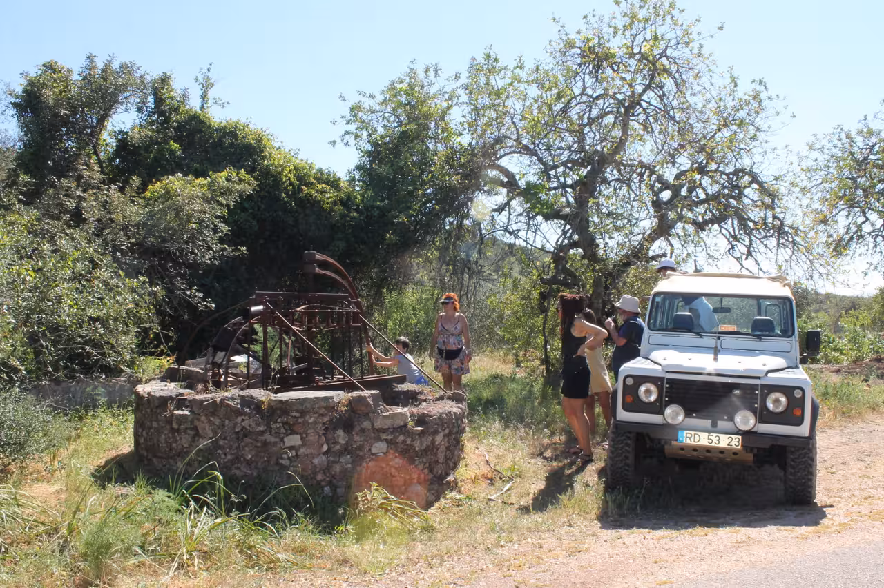 4x4 Jeep safari group exploring a traditional Algarve well and waterwheel on Benagil coast tour