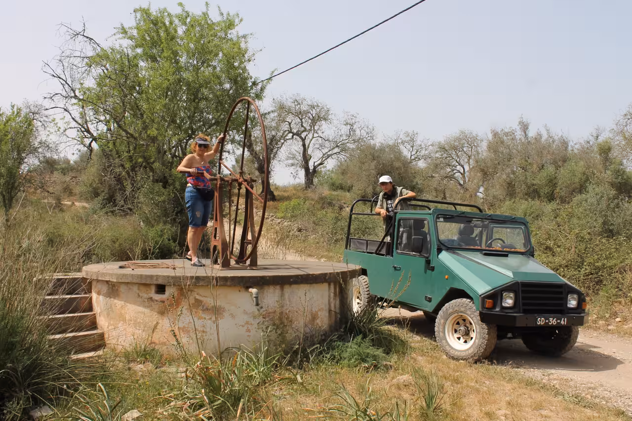 Guests at a rustic well during Algarve Jeep Safari Coast Tour, scenic countryside stop on the way to Benagil cliffs