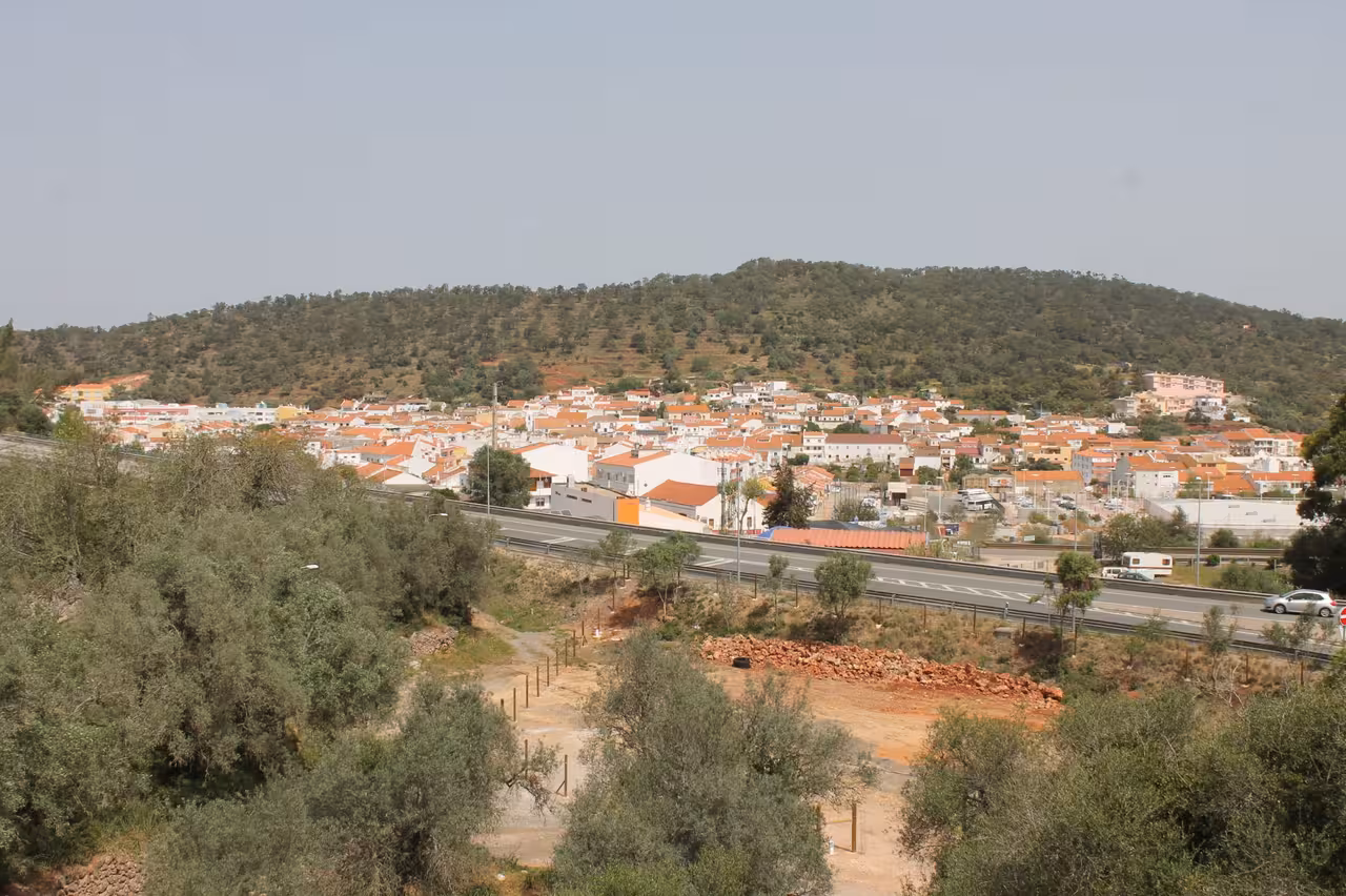 Panoramic countryside viewpoint on a jeep safari tour overlooking a hillside village with red-tiled roofs