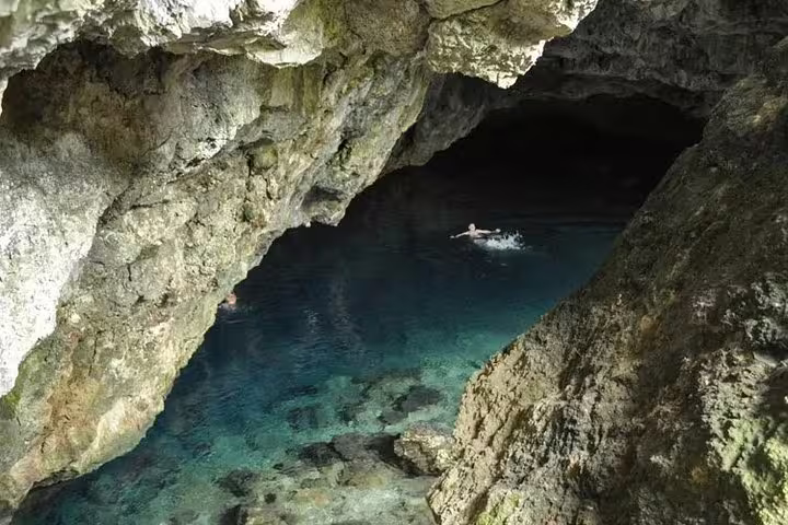 Explore a hidden cave with crystal-clear waters, perfect for swimming on a Jeep Safari from Kusadasi Port.