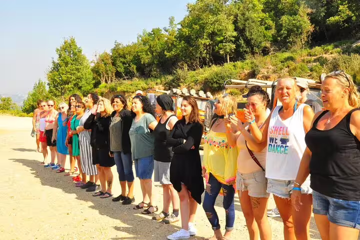 Group of excited tourists ready for a Jeep Safari adventure near Kusadasi, enjoying the sunny day.