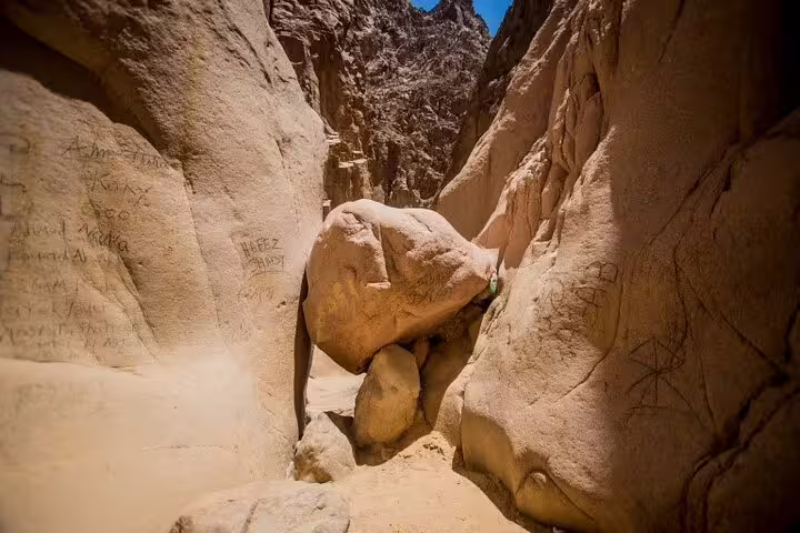 Narrow Sinai canyon with huge boulder on Jeep safari to Lost Lake and Dahab from Sharm El Sheikh