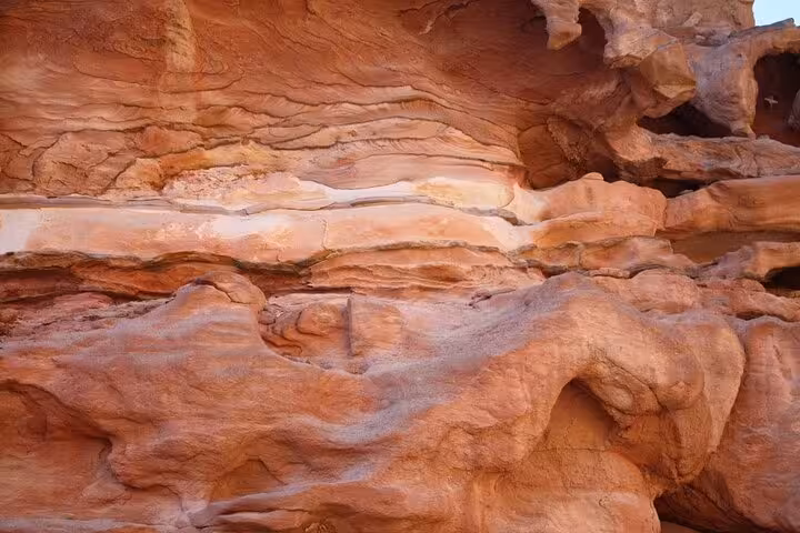Layered sandstone walls inside Salama Canyon on a Jeep safari day trip from Sharm El Sheikh to Dahab
