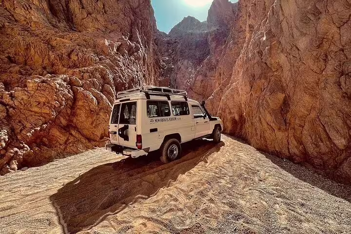 4x4 Jeep driving through Sinai desert canyon on private Sharm El Sheikh to Dahab and Lost Lake safari tour