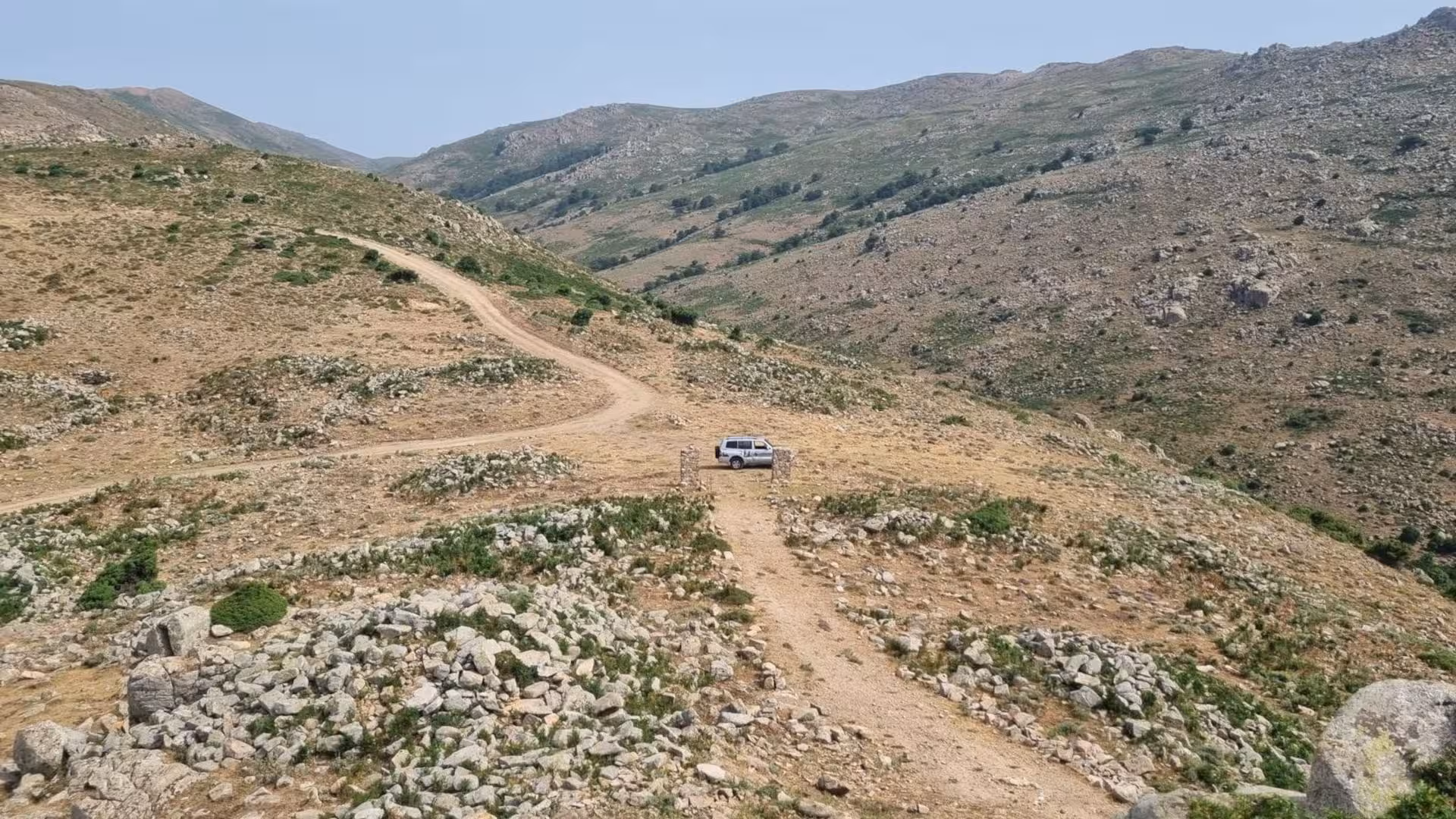 Off-road jeep on a rugged mountain trail in Barbagia, showcasing the adventurous spirit of Arbatax tours.