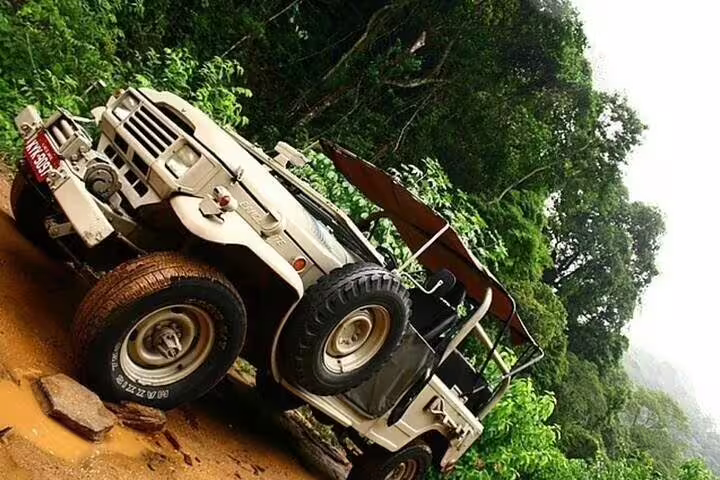 A rugged jeep parked on a muddy trail, showcasing the adventurous off-road experience in Tijuca Rainforest, Rio de Janeiro.