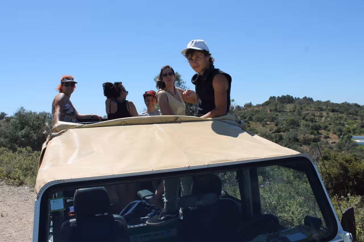 Guests riding open-top Jeep on Jeep Zoofari safari tour, enjoying panoramic views and off-road adventure