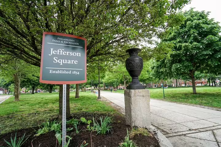 Jefferson Square park sign established 1854 Philadelphia Parks and Recreation with decorative urn on stone pedestal