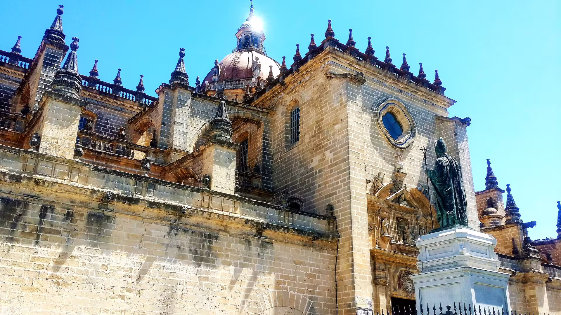Jerez Cathedral facade and dome under blue sky, highlight of private tour with hotel pick-up from western Costa del Sol