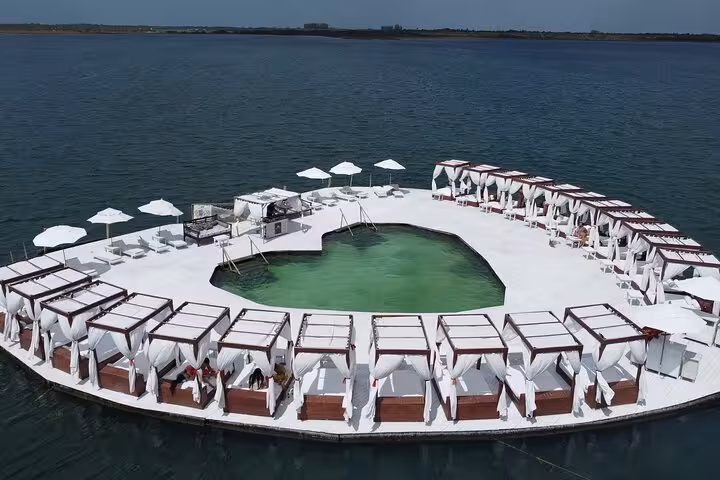 Floating beach club with cabanas and pool on the lagoon, a relaxing stop on Jericoacoara East Coast tour