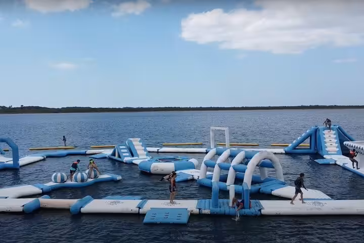 Floating inflatable water park on a lagoon stop during Jericoacoara East Coast tour, fun for families