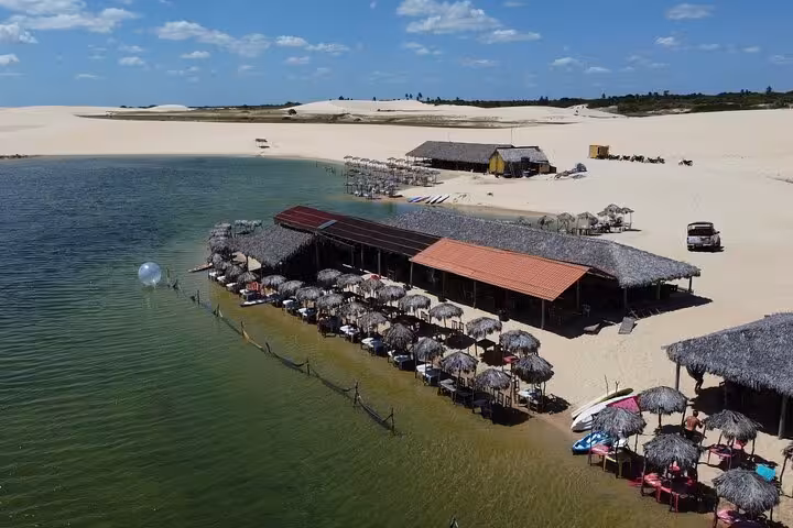 Aerial view of Lagoa Azul beach bars and dunes on Jericoacoara West Coast 4x4 tour, Ceará Brazil