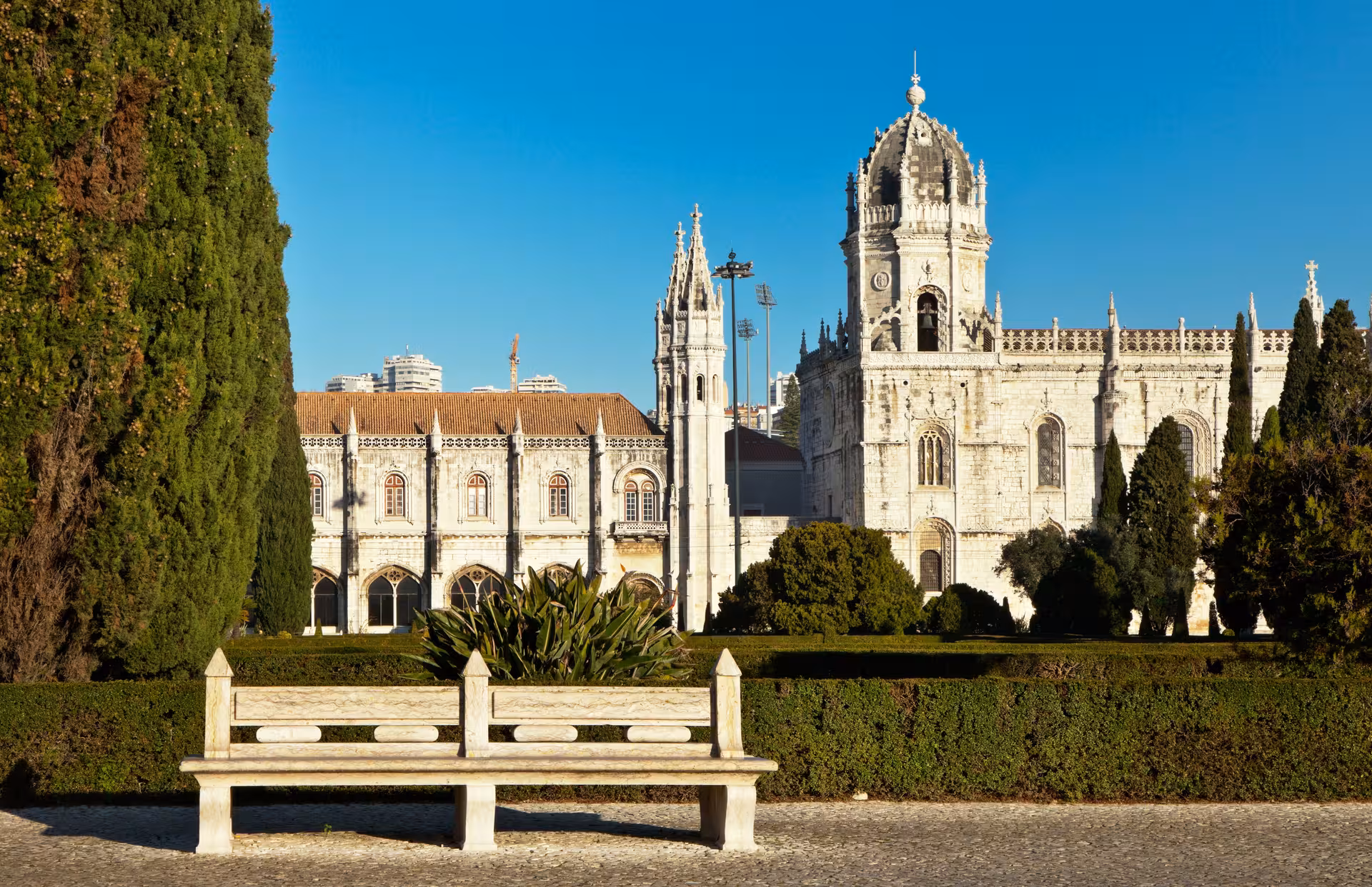 Discover the stunning architecture of Jerónimos Monastery surrounded by gardens in Belém, Lisbon.