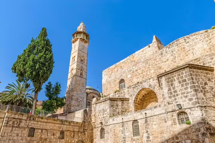 Ancient stone walls and minaret tower near Church of Holy Sepulchre in Jerusalem's Old City